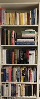 Shelf full of various hardback books on art, history, biographies, and anthropology