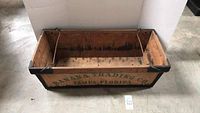 Side view of the wooden crate showing Banana Trading Co. Tampa Florida painted text on the side
