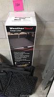 Photo of new WeatherTech cargo liner in box, showing packaging and some visible text and graphics.