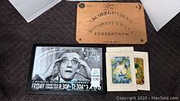 Photo showing the wooden Ouija board, framed Gypsy Native black and white promotional poster, and a set of assorted art cards.