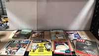 Collection of vintage magazines including Look, Post, Time, Life, World Week laid out on table