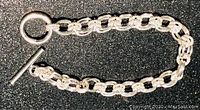 Full view of the sterling silver 925 ladies toggle end bracelet with unique textured link design.