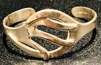 Front view of unique sterling silver cuff bracelet showcasing artistic curvy design with rounded bars and open cut-outs.