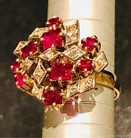 Top-down view of ring showing seven rectangular rubies and alternating diamond-shaped settings with diamonds