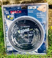 Front view of Bosch circular saw blade in original plastic packaging showing branding, 10 inch size, 80 teeth, general purpose blade with carbide tips