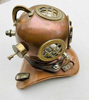 Angled side view of copper helmet showing side port grille and fittings