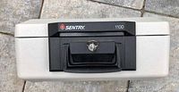 Top view of the Sentry 1100 fire safe showing the black lock and handle with keys inserted.