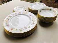 Three stacks showing large dinner plates, smaller dessert plates, and bowls