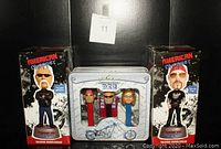 Two boxed American Chopper talking bobbleheads and a PEZ dispenser candy set with three character dispensers in a metal collectible tin, all brand new.