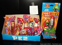 Photo showing eight sealed assorted PEZ dispensers and large sealed Marvin The Martian PEZ dispenser with display box