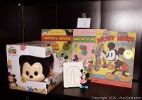 Disney Tsum Tsum Stack 'n' Display Set with three replica Mickey Mouse books and a Minnie Mouse ceramic frame, plus exclusive boxed figurine.