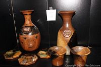 Both decanters, two cups, and three stone & wood coasters on black shelf background.