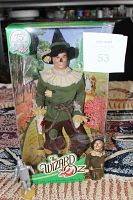 Photo of the 12-inch Mattel Scarecrow doll in original boxed packaging labeled with 75th Anniversary logo and The Wizard of Oz graphics.