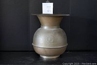Full front view of the brass spittoon showing its overall shape and branding.
