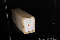 Original white storage box labeled 83 with some age marks.