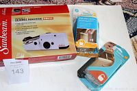 Photo of Sunbeam SB011 hand held sewing machine box with two safety latch packs