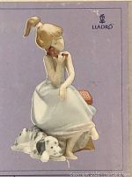 Front view of box cover showing the figurine of girl and dog with Lladro logo
