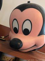 Close-up of the front of the Mickey Mouse shaped plastic lunchbox showing detailed face and black ears.