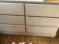 Front view of the white dresser showing six drawers arranged in two columns of three.