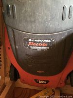 Front view of the mower showing the Lawn Hog Electric 19" Mulching Mower label and Black & Decker brand.
