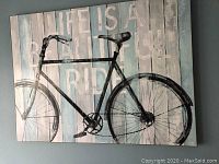 Front view of the bicycle wall artwork showing the design and text clearly