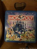 Photo of the Monopoly game tin featuring classic Disney characters and branding