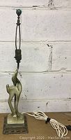 Full view of the vintage green ceramic deer lamp with metal base, showing the full height and lamp socket.