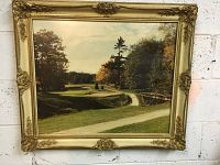 Front full view of the ornate gold frame containing the golf course photograph print.