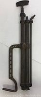 Full front view of the Femyers Bro antique metal hand pump tool showing dual cylinders and side handle.