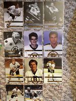 Photo of 11 Boston Bruins hockey cards including Brad Park, Doug Mohns (2 cards), Don Awrey, Matt Glennon, Billy O'Dwyer, Joe Berry, Frank Simonetti, Tom Gorence, and one signed card.