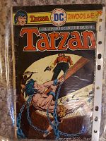 Cover of Tarzan comic book, showing yellow DC logo, title 'Diamond Slaves', and action scene with Tarzan chained fighting a man with a gun.