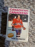 Front view of Yvon Cournoyer hockey card from 1975-76 OPC set showing player in Canadiens red uniform on ice, card in very good condition.