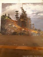 Original landscape painting showing a hillside with trees and cloudy sky, some wear and damage at bottom edge.