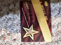 Front of the card showing a fabric swatch embedded behind a gold star cutout and title mentioning it is a piece of Tom Cruise's costume worn in A Few Good Men.