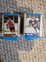 Pile of 1989-90 OPC hockey cards with visible Mark Howe and Benoit Hogue cards on top, laid on carpet.