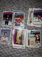 Top view of six 1976-77 OPC hockey cards featuring players Marcel Dionne, Mel Bridgman, Steve Shutt, Doug Jarvis, Bill Barber and a team photo of John Davidson.