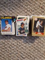 Three stacks of baseball cards shown from above, featuring first visible cards from Padres and Indians teams.