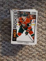Tyler Cuma Hot Rookies hockey card showing front image of player in green and red uniform with the number 65.