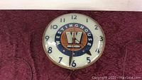 Front view of clock face showing Westinghouse logo and hands