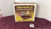 Original box of Supermatic II cigarette maker with product image and branding.