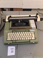 Photo of green Smith-Corona Coronamatic 2020 electric typewriter showing keyboard and platen