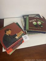 Top view of vinyl records showing cover with man reading.