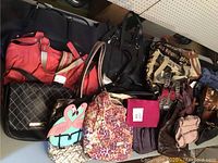 Full view of purses arranged on table showing various colors and styles