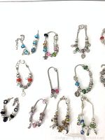 Full view of 11 assorted Italian glass charm bracelets on white background showing bead and charm detail.