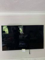 Front view of mounted TV showing overall condition