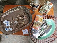 Overview of collection showing silver serving tray with handles filled with assorted silverware and napkin rings, German beer stein, ceramic platter, floral tin recipe box, and souvenir coasters.