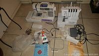 Overview of Brother SE400 sewing/embroidery machine (left) and Brother 1634D serger (right) with accessories laid out