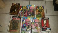 Overview of all action figures in original packaging including Austin Powers figures, Spawn, and Rocky Horror Picture Show bobblehead
