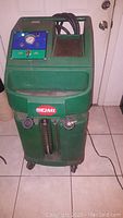 Front view of green QMI coolant exchanger service machine