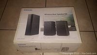 Outer box of Samsung Wireless Rear Speaker Kit with model SWA-9000S displayed on box
